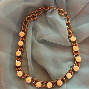 Daisy’s on a gold thick chain.